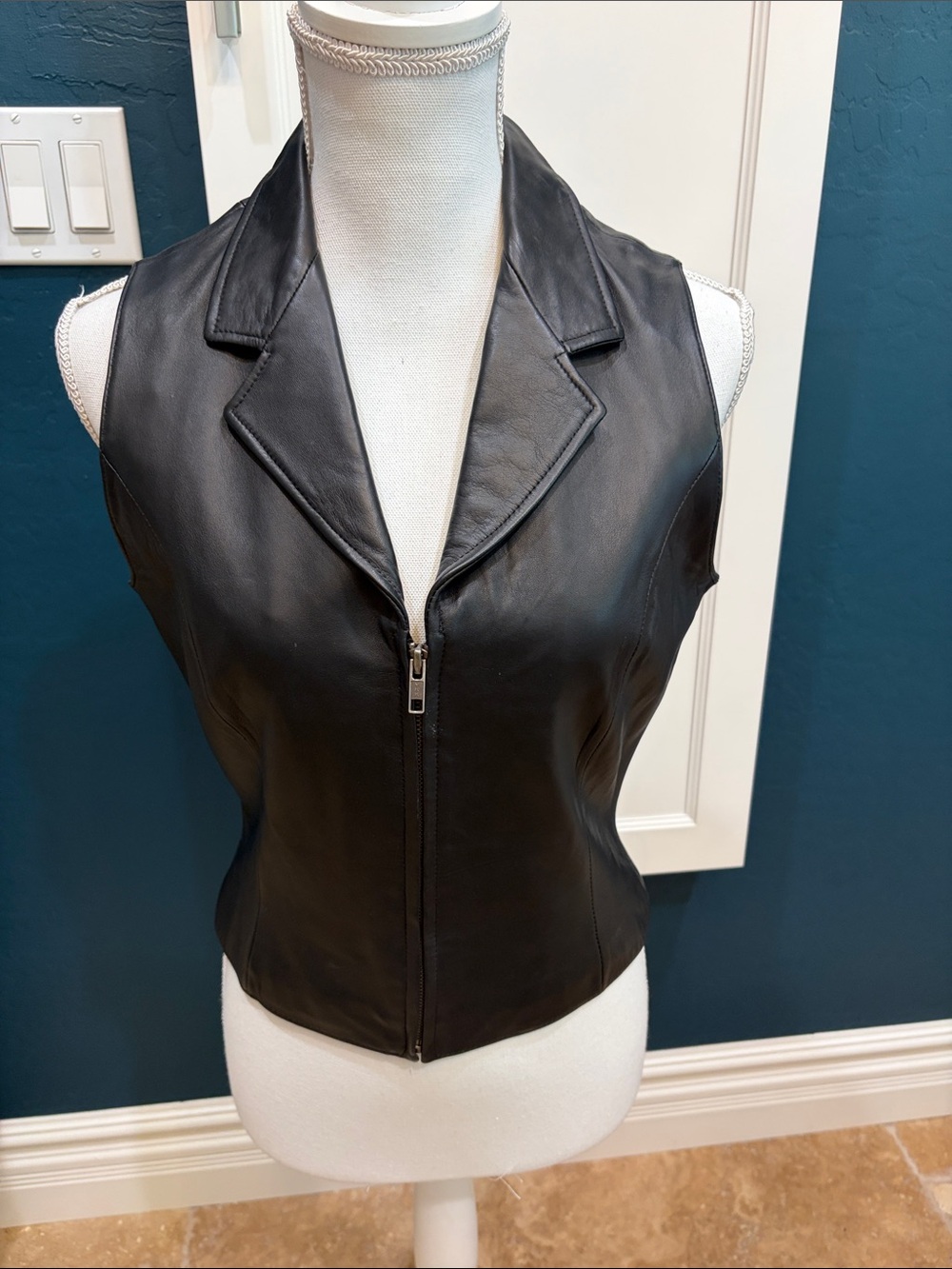 Wilson’s black leather V-neck vest